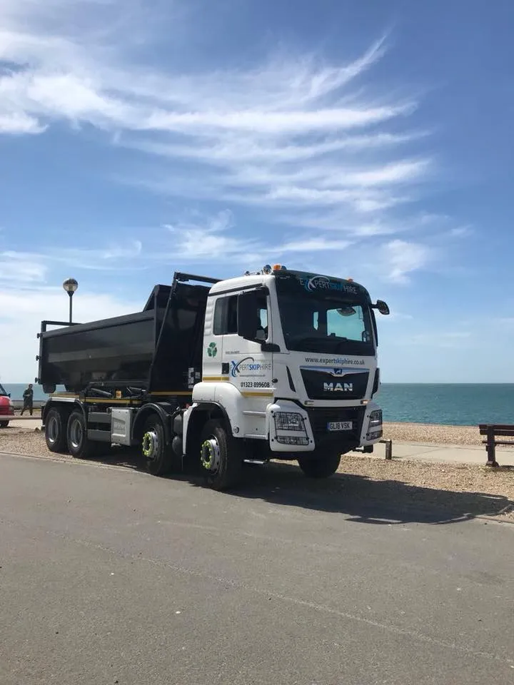 skip lorry parked by the sea

