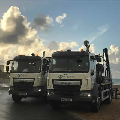 2 skip lorries side by side
